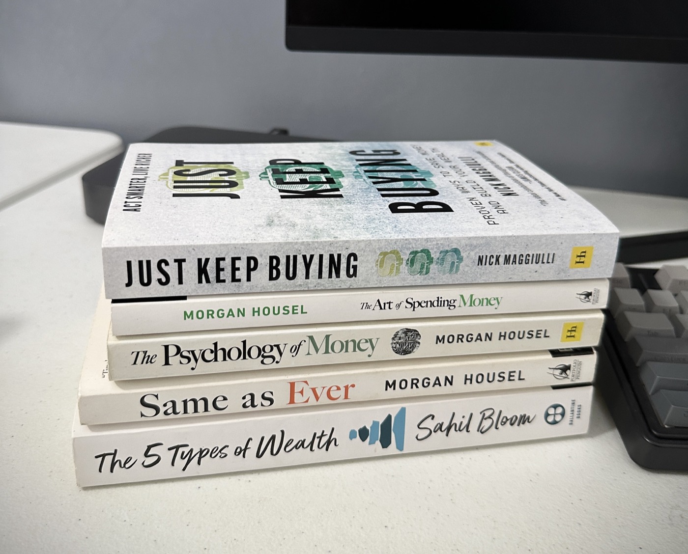 Stack of finance and business books on John Arce's desk