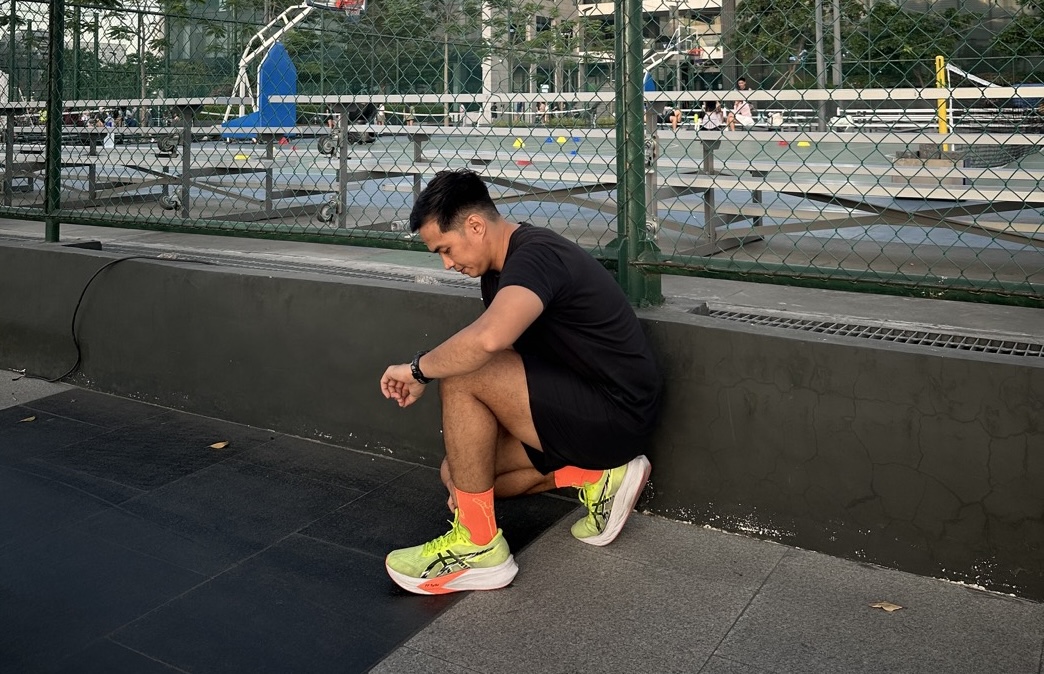 John Arce checking his watch after a training run