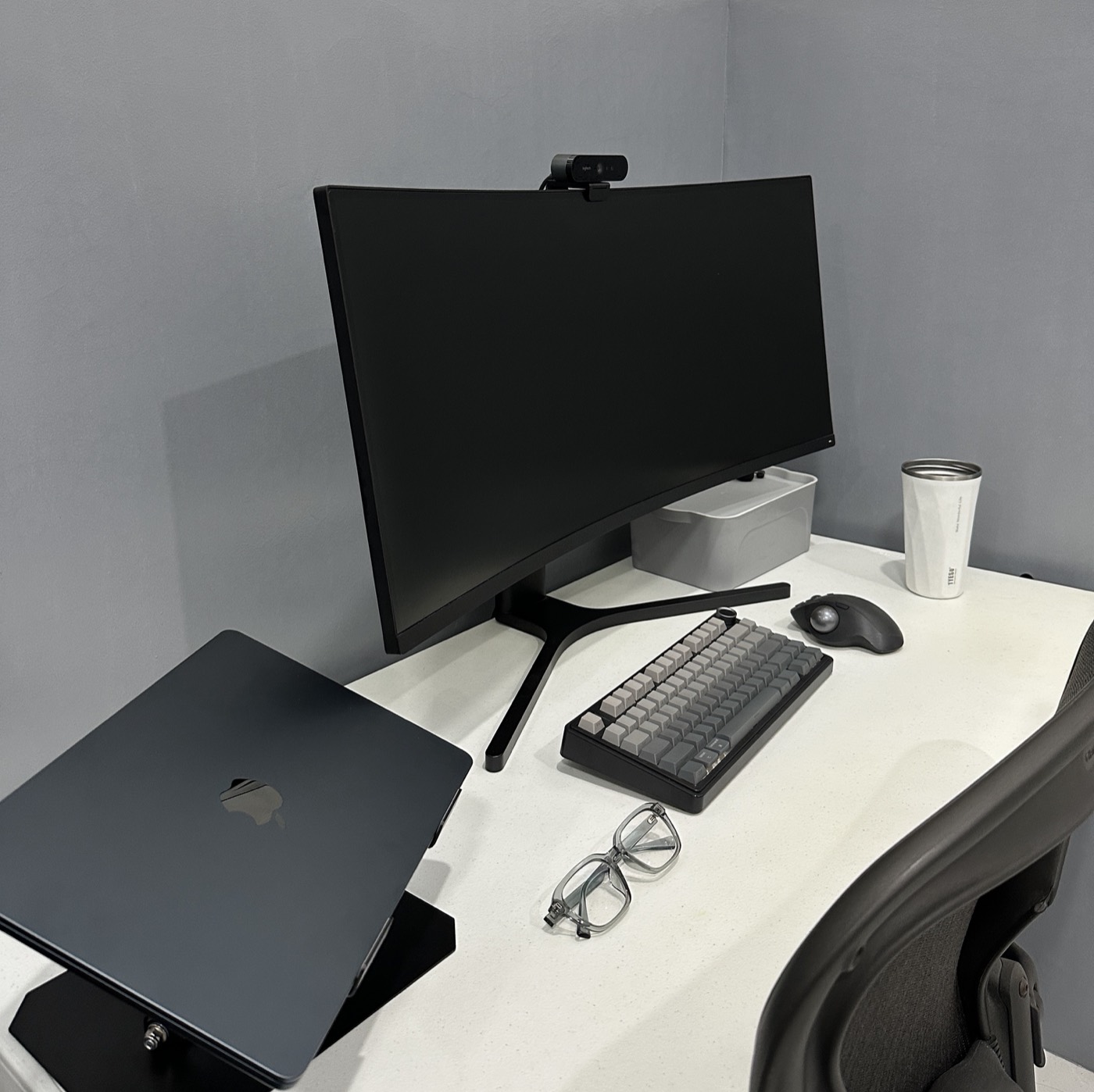 John Arce's minimal desk setup with monitor, keyboard, and trackball mouse