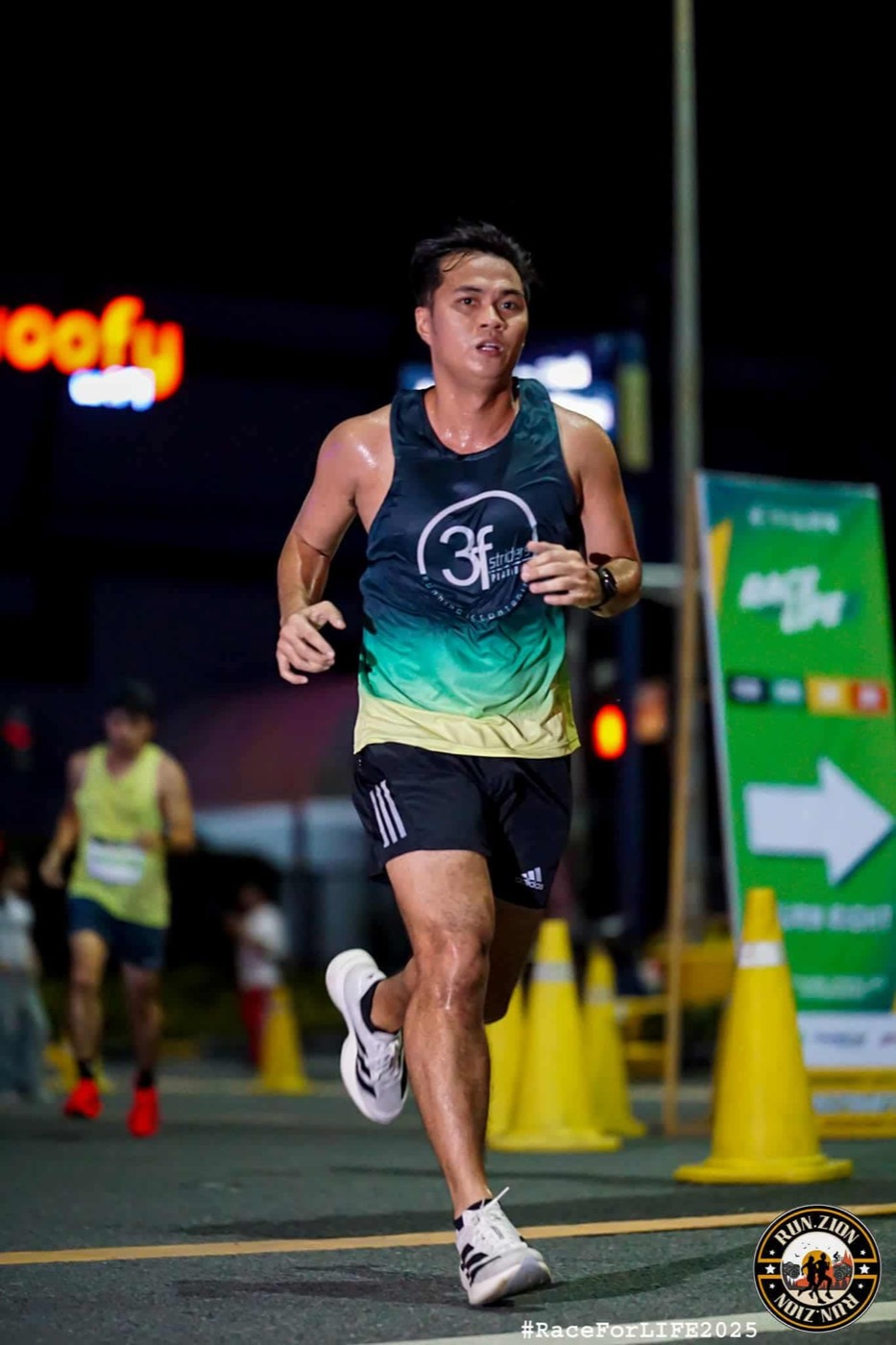John Arce running a race wearing a faith-based running club singlet