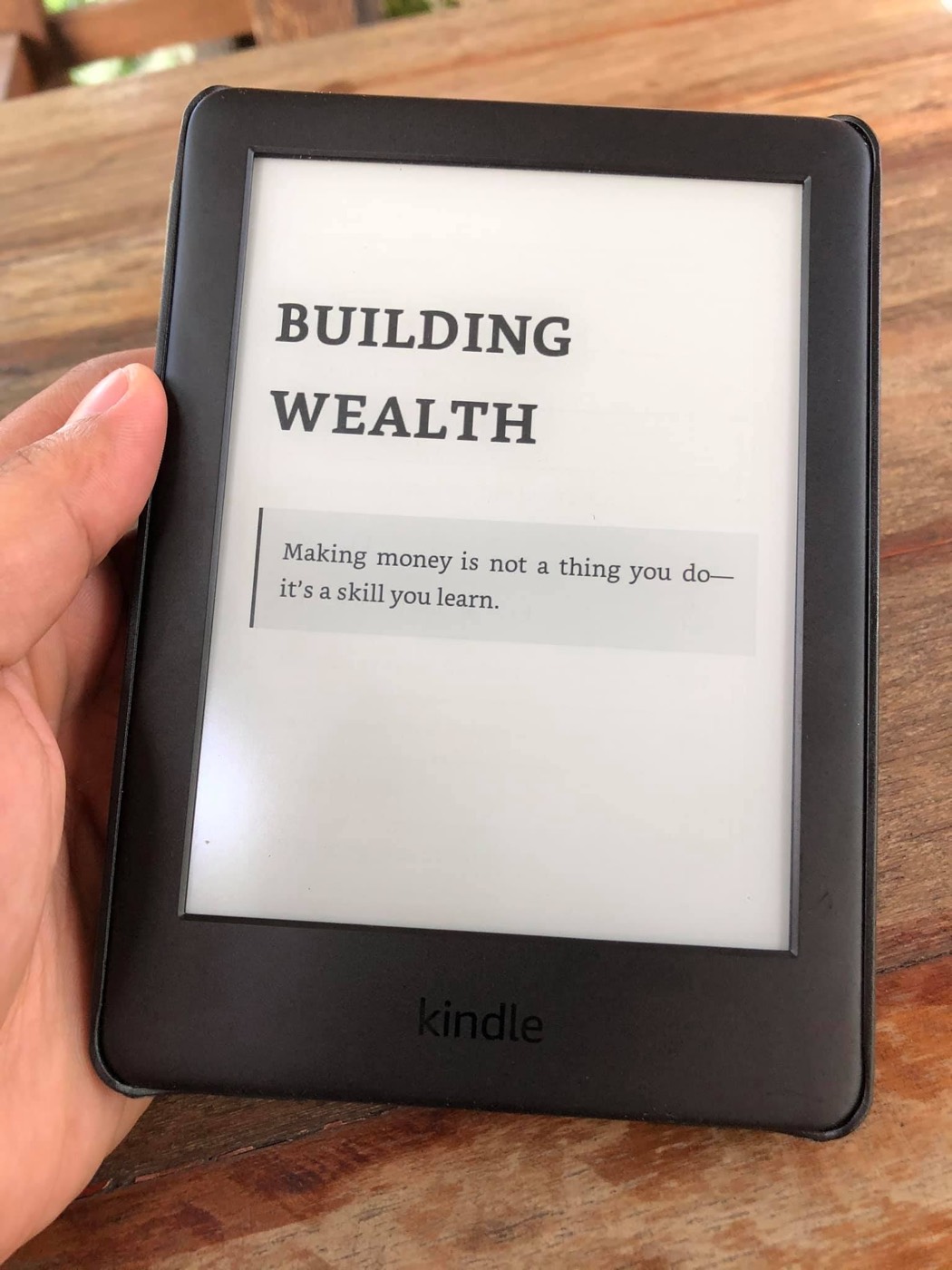 Kindle showing a quote: making money is not a thing you do, it's a skill you learn